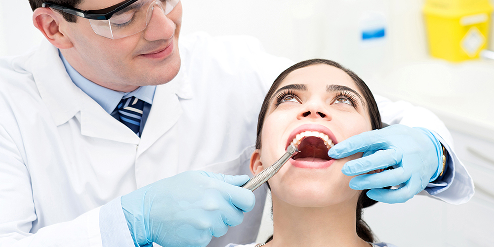Teeth exam being conducted during an initial dental exam