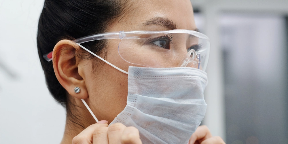 A dental professional wearing COVID-19 personal protective equipment