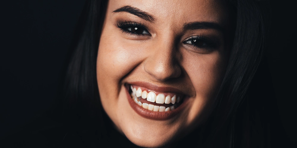 A women smiling after receiving her dental onlays