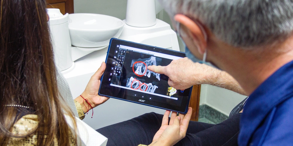 A dentist that patient reviewing the root canal examination