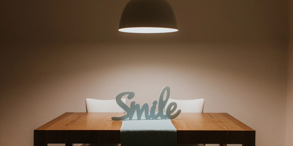 A sign on a table that says "Smile" because we want you to treat your sleep apnea and be happy